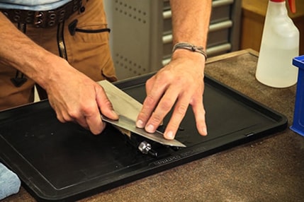 Knife sharpening on bench stone Knife sharpening on bench stone